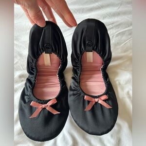 Black slippers with pink bows